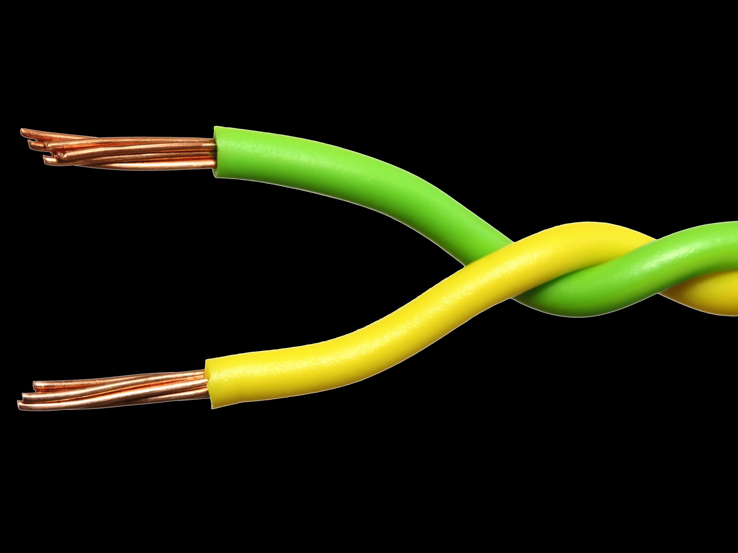 A pair of twisted copper cables with green and yellow insulation