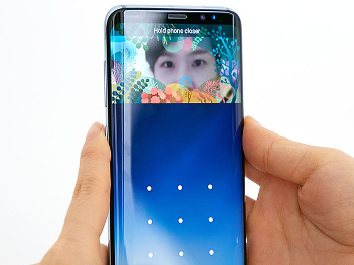 A person holds a new Samsung Galaxy S8 smartphone in front of their eyes to unlock their phone using iris scanning technology.