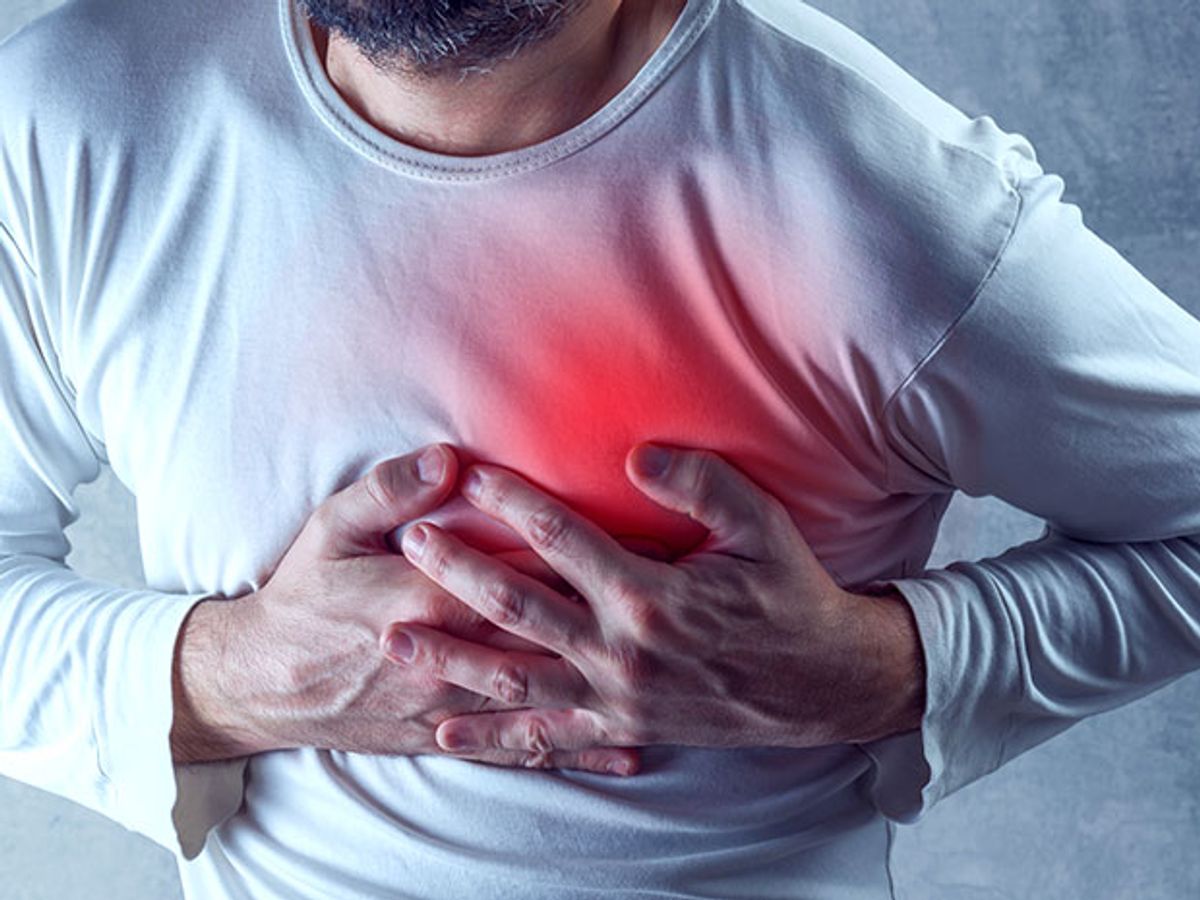 A photo-illustration shows a man clutching his chest, which is emitting a red glow to indicate a heart attack.