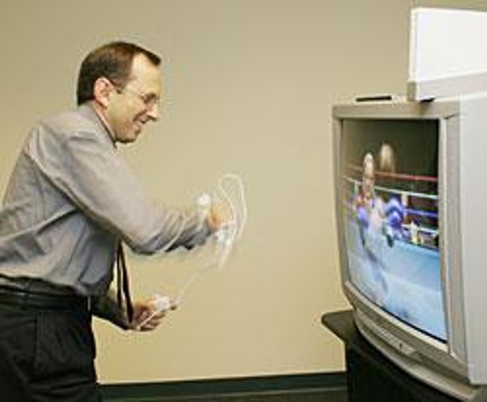 A photo of a man play nintendo Wii
