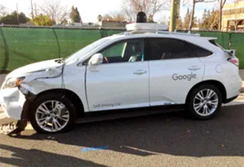 A photo of a white car with damage on the front end and the words \u201cSelf Driving Car\u201d and \u201cGoogle\u201d on the side.