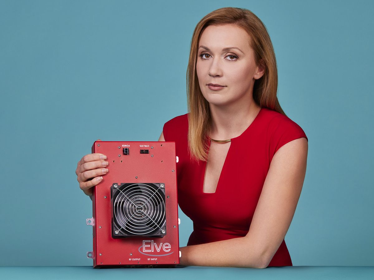 A photo of a woman in a red dress holding a red device with "Elve" on the front.