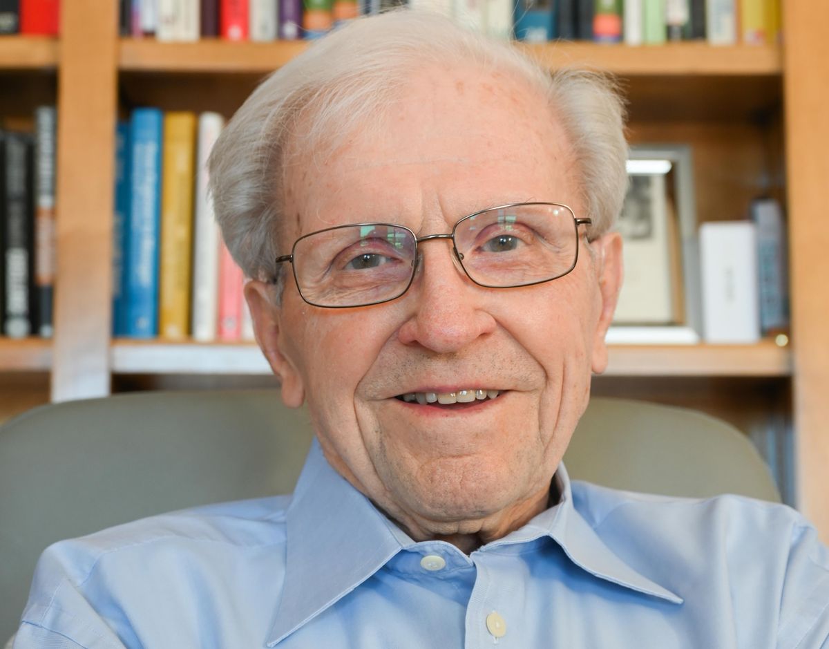 A photo of an older smiling man in glasses.  