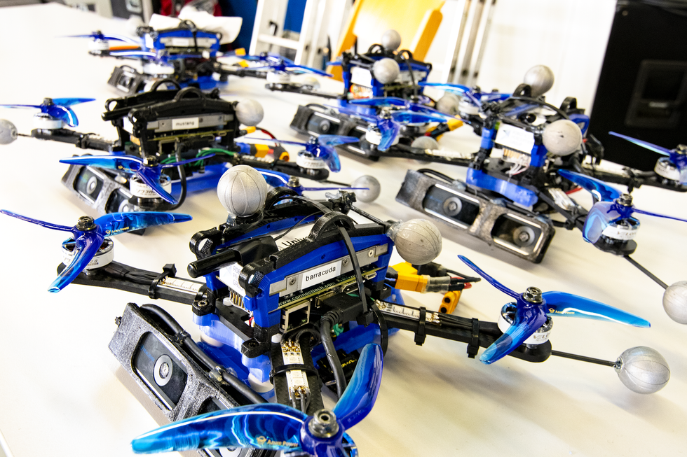 A photo of blue drones on the ground.