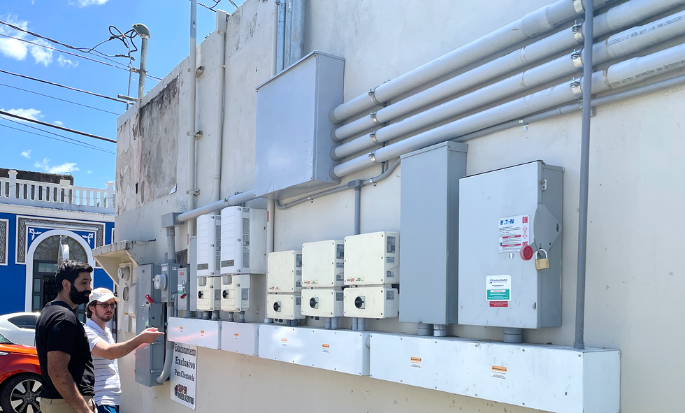 A photo of electrical equipment mounted on the exterior of a building.