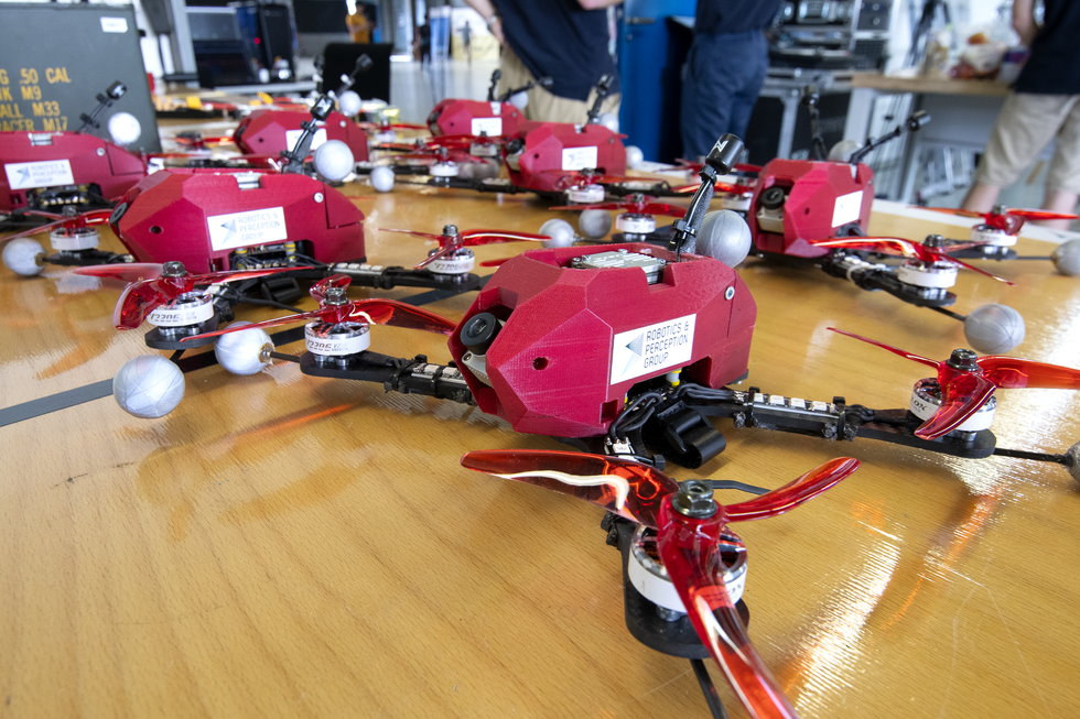 A photo of red drones on a table.  