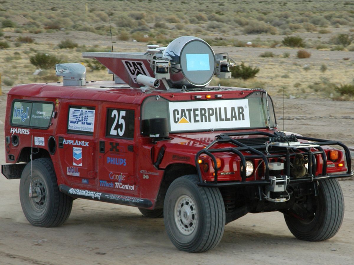 A photo of the red H1ghlander truck on a desert road.