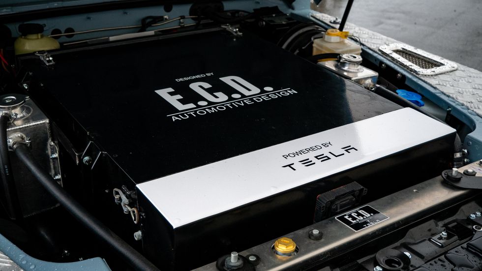 A photo of what is seen under the hood: a large metal box marked 