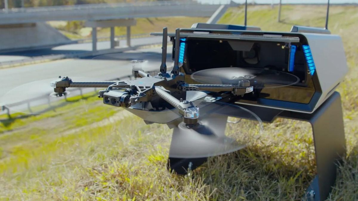 A photo showing an autonomous drone launching itself from a metal box on the side of a highway