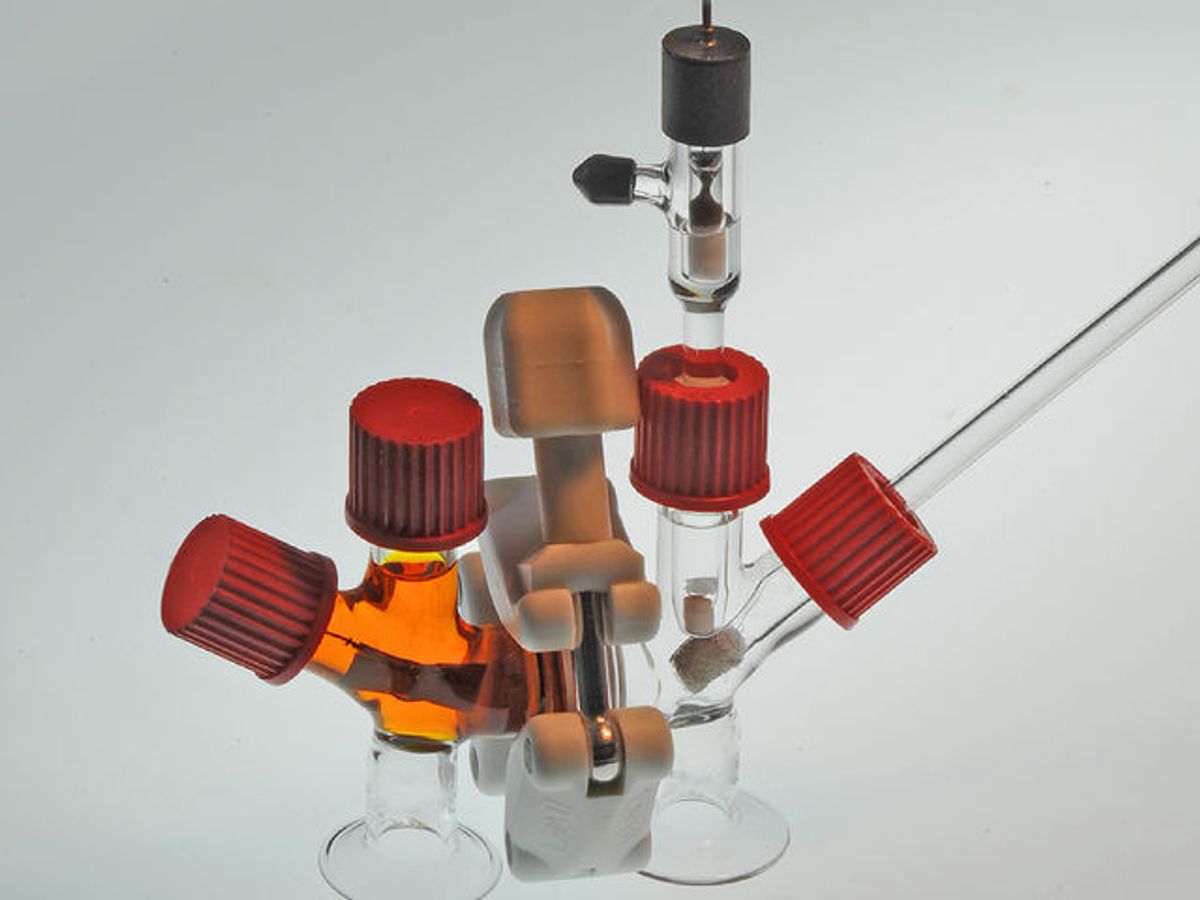 A photo shows an “air-breathing” battery made of clear glass tubins with red caps and an orange liquid in one half.