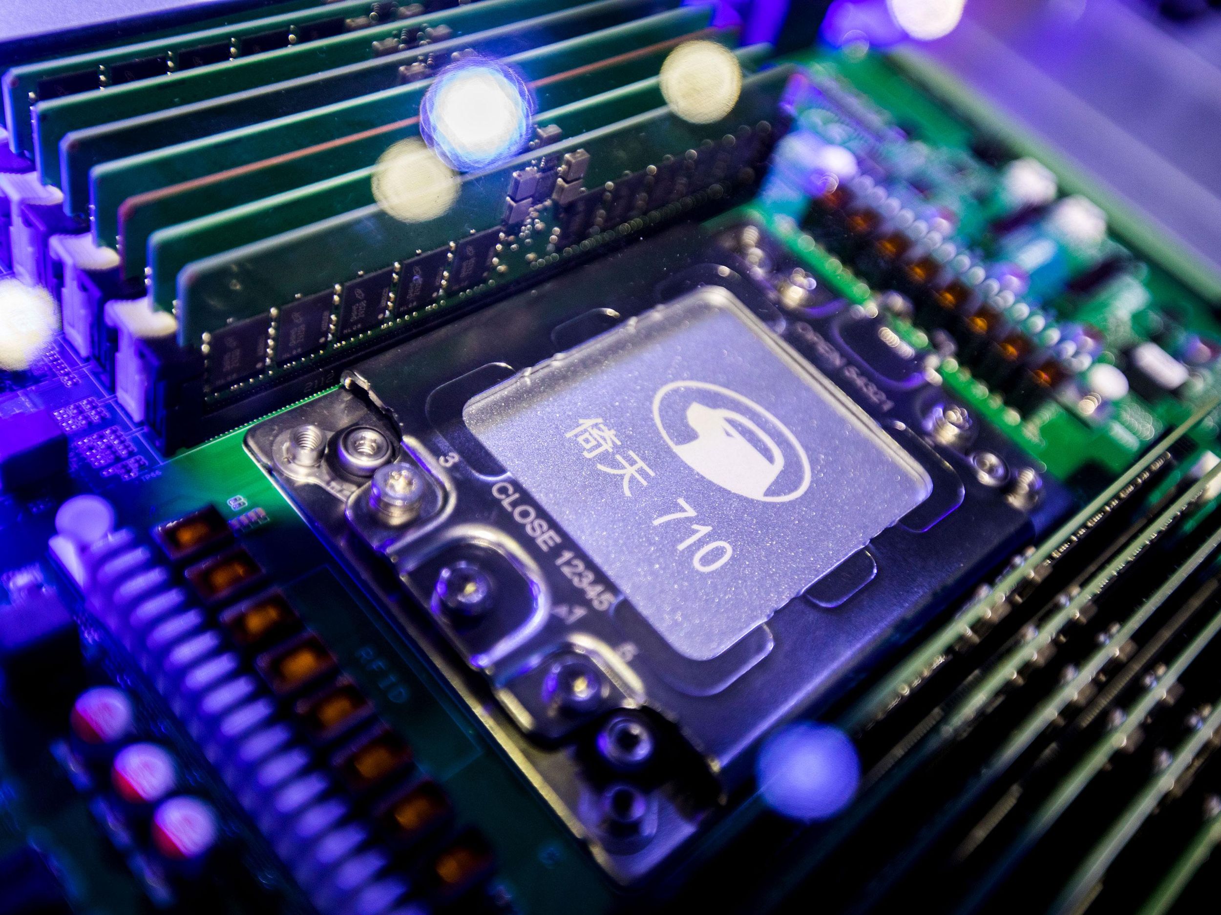 ​A photograph of a computer motherboard. In the center is a relatively large chip with Chinese lettering and the number 710 