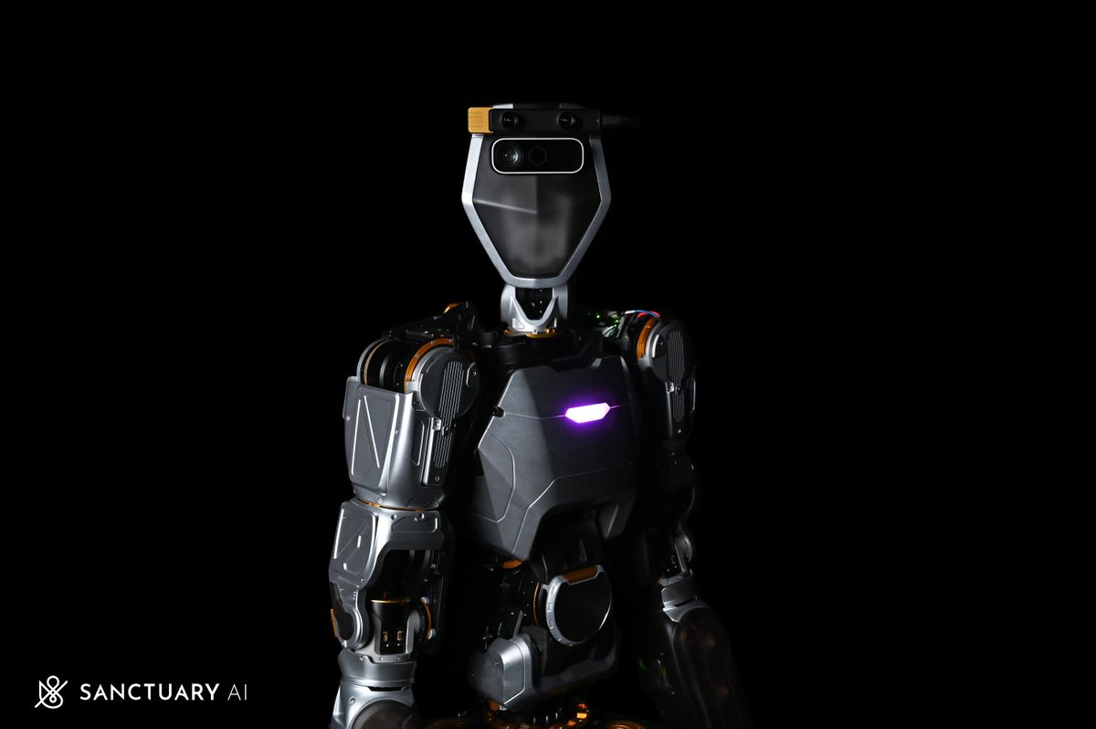 A photograph of a futuristic looking dark colored angular humanoid robot from the waist up