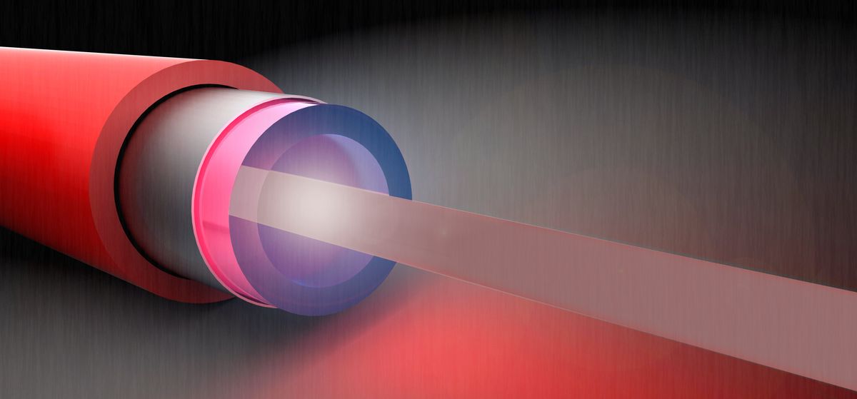 A red coaxial cable with purple inner cladding beams out a laser
