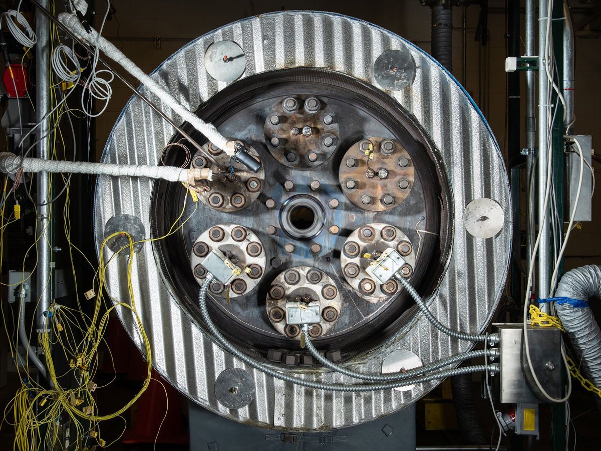 A ring of corrugated metal with several circles of metal within it. Thick and thin wires attach to the inner circles.