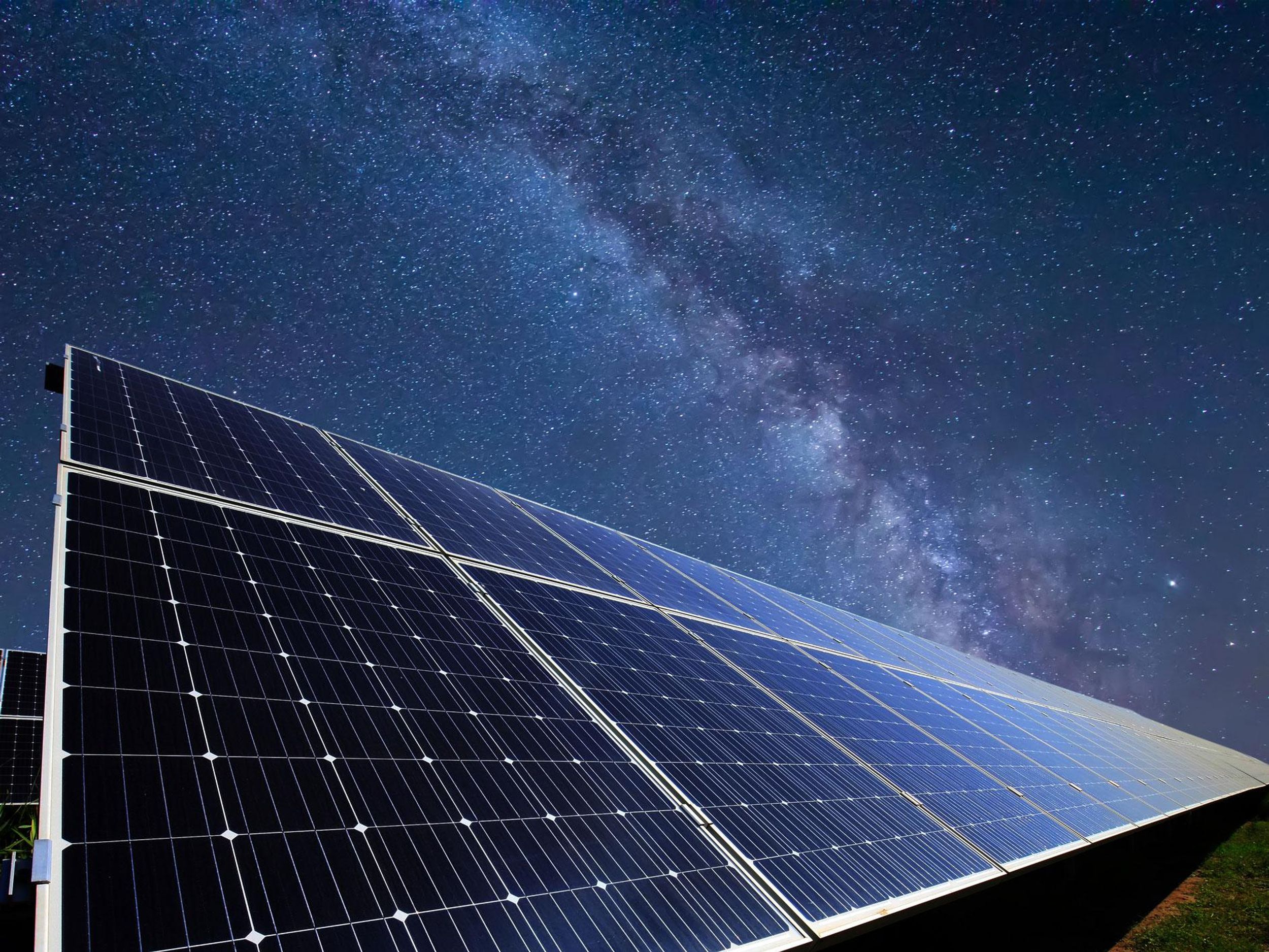 a row of solar cells underneath a starry nighttime sky