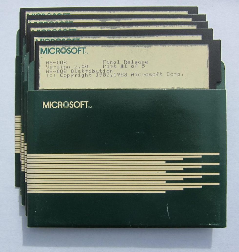 A set of 5 computer floppy disks in sleeves labelled u201cMicrosoft.u201d 
