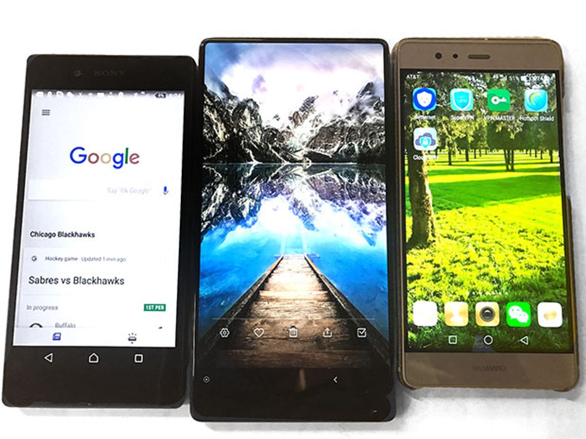 A Sony Android smartphone, a Mi Mix smartphone, and an iPhone placed side by side, showing the larger screen of the Mi Mix