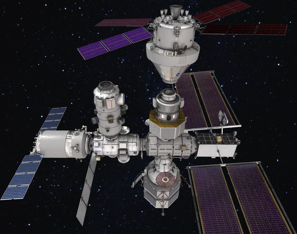 A space station is shown laid out from left to right along a cylindrical structure, with smaller structures projecting orthogonally. At either end of the space station are solar panels.