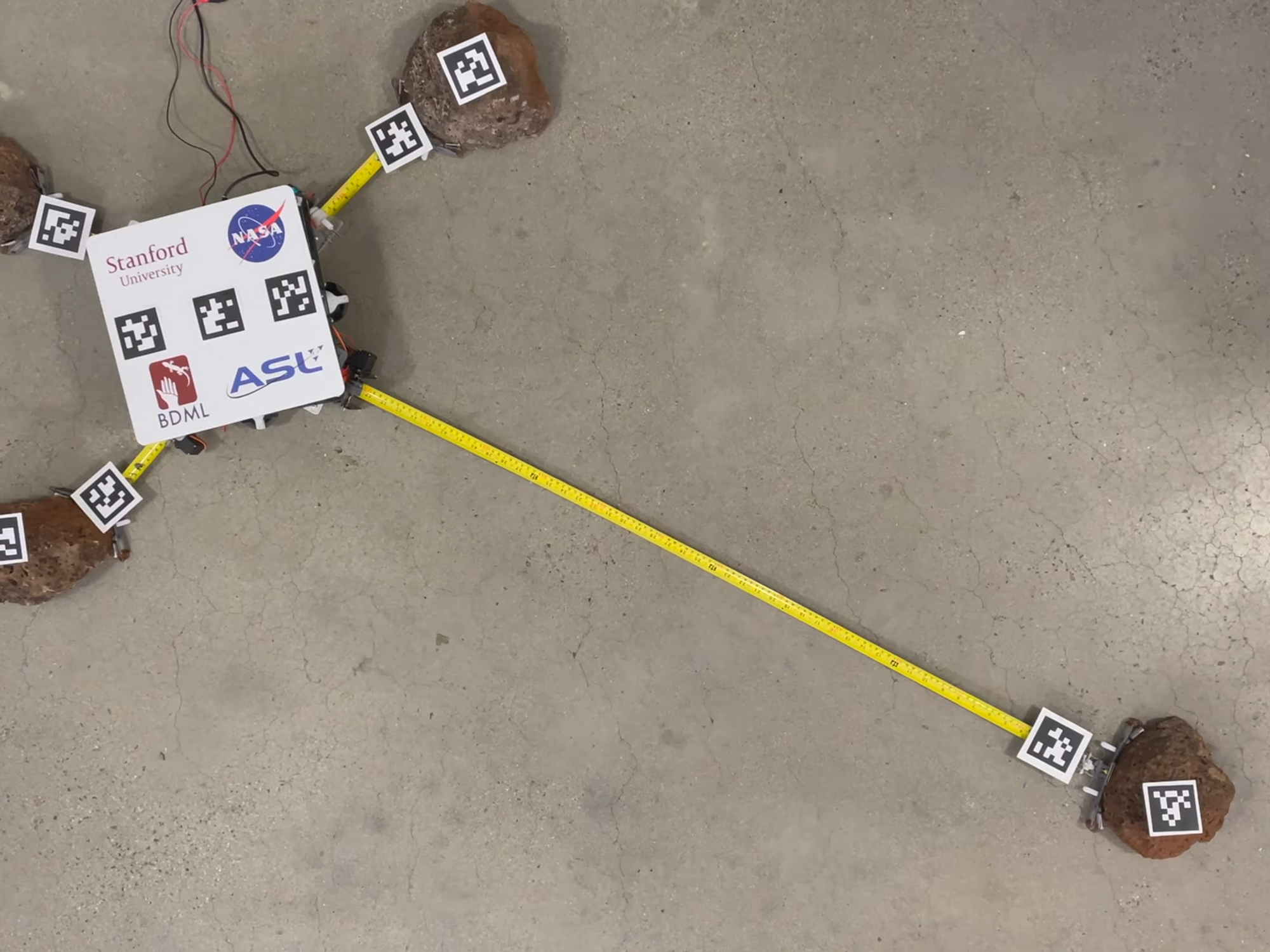 a-square-white-robot-on-a-concrete-floor