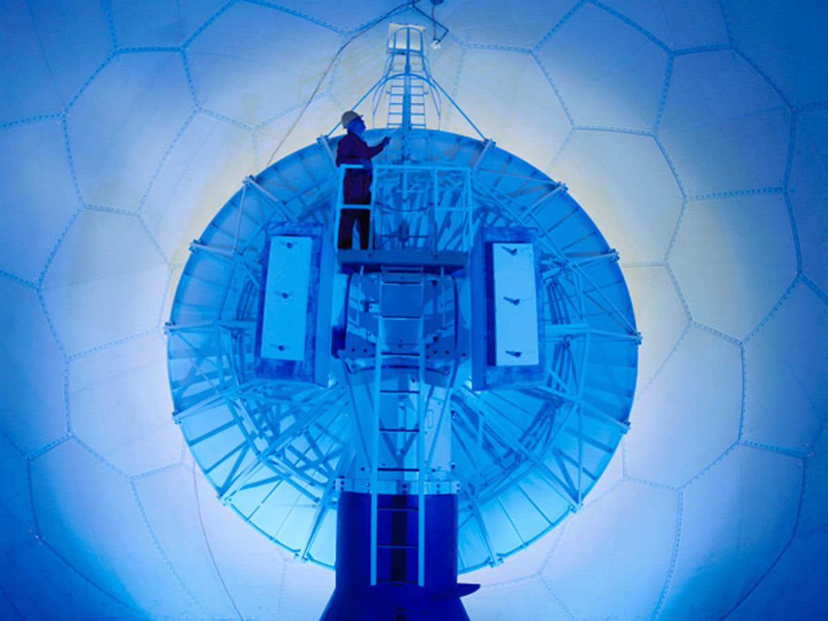 A technician works on a Doppler weather radar’s parabolic antenna, which is situated within a large tiled dome.