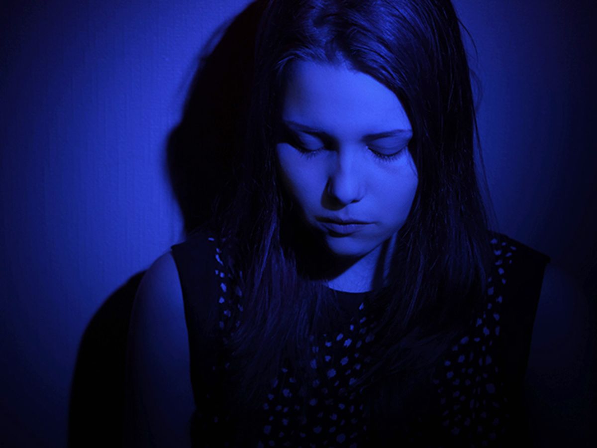 A teenage girl looks sad