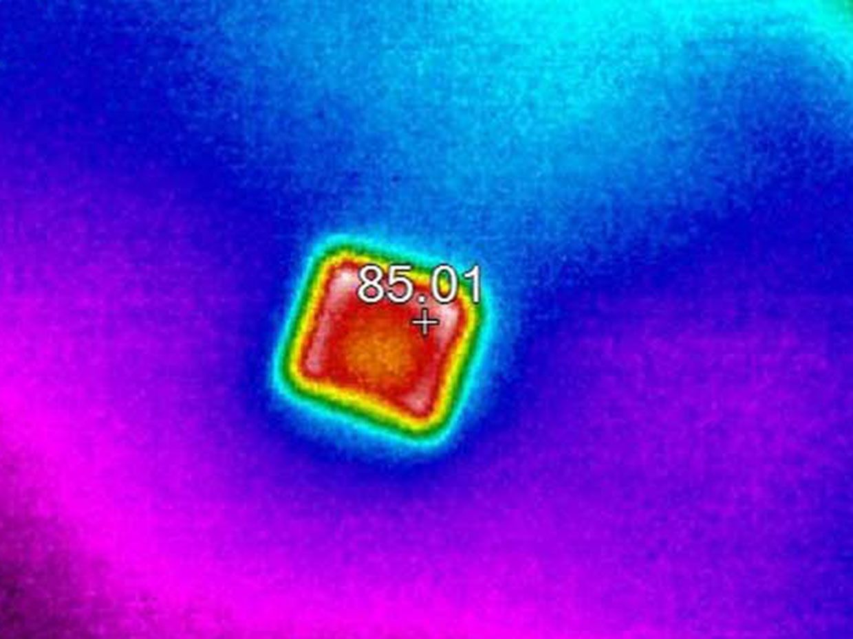 A thermal image of a nanoparticle as it absorbs solar radiation.