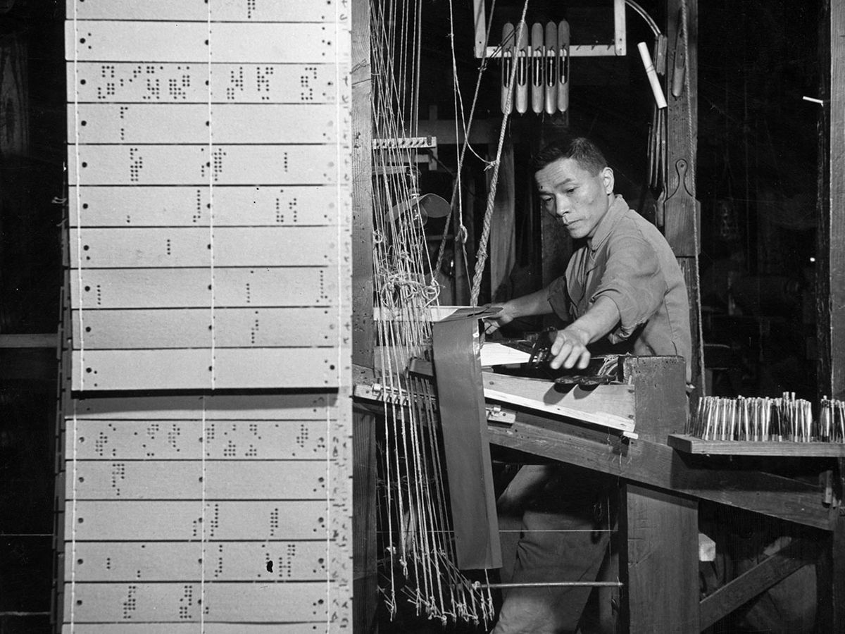 A weaver at work in 1955 on one of the Jacquard looms at a Nishijin plant in Kyoto, Japan.