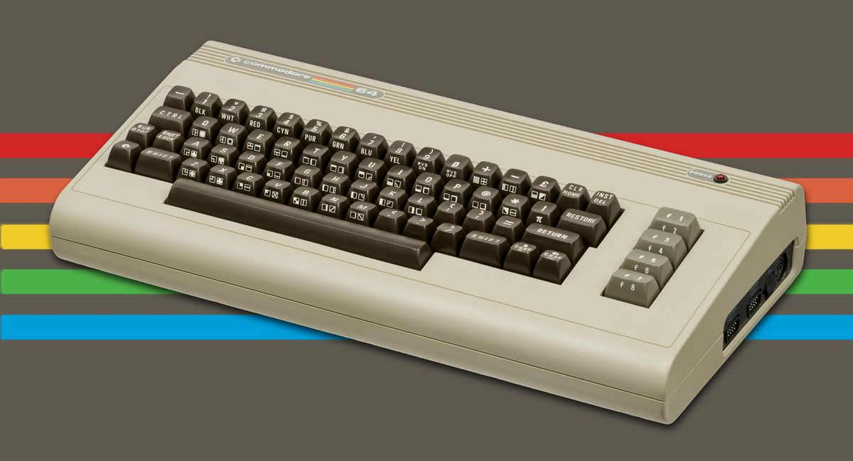 A wedge-shaped beige keyboard with dark keys and the Commodore 64 logo on a grey background with red, salmon, yellow, green and blue stripes.