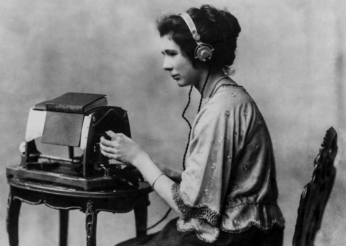 A woman listening to a device.