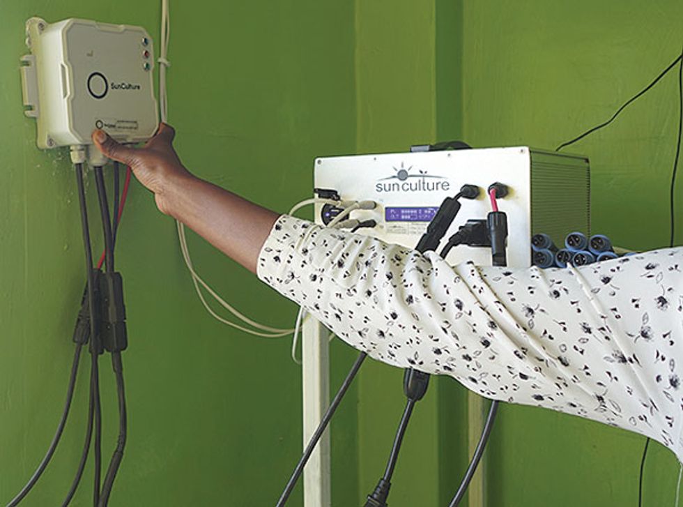 A woman's hand on a SunCulture controller