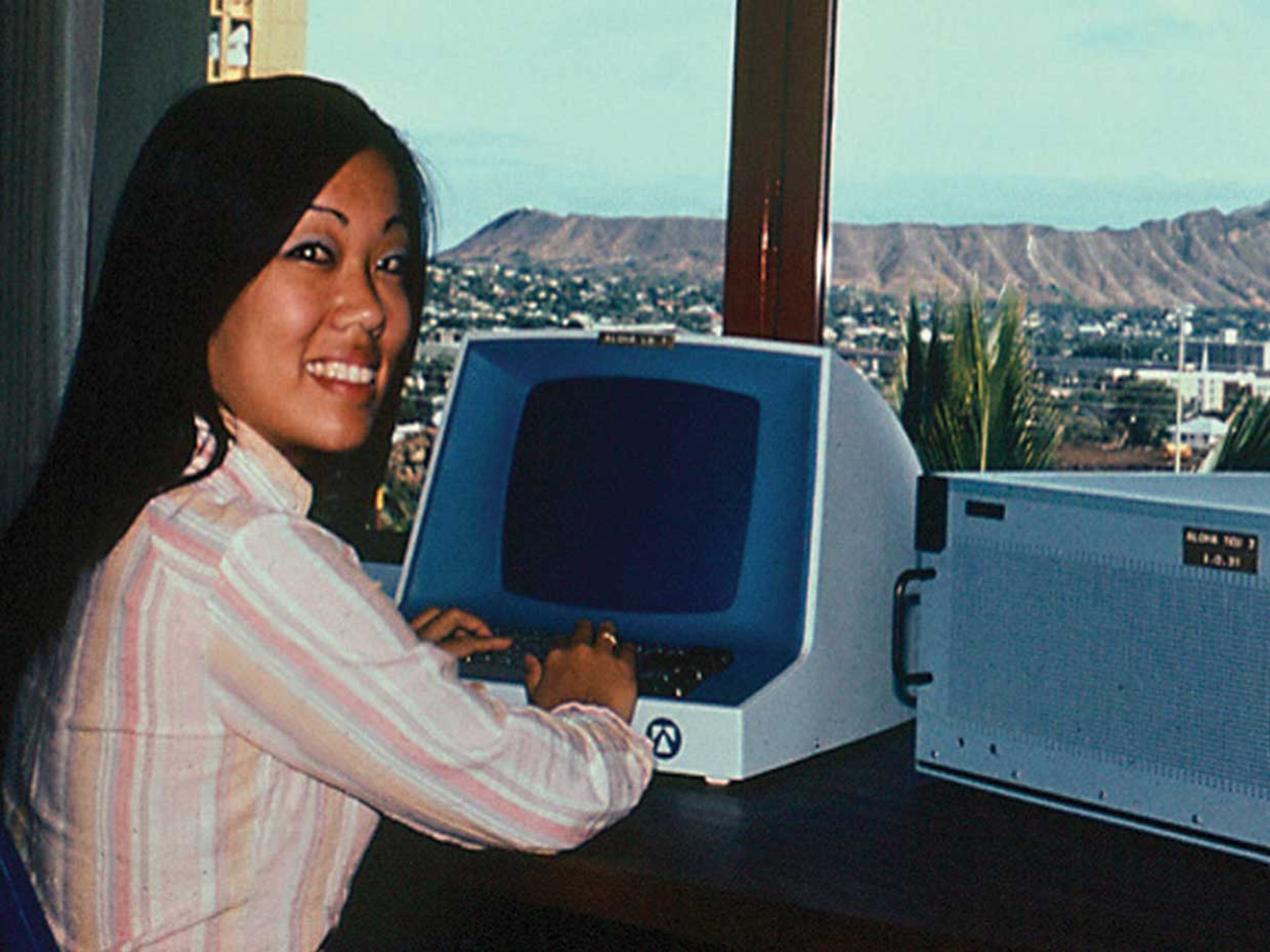 A woman sits in front of an AlohaNET computer in 1971.