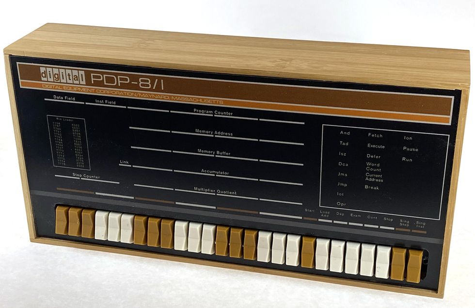 A wooden box with brown and white keys along the bottom labelled digital PDP-8/I