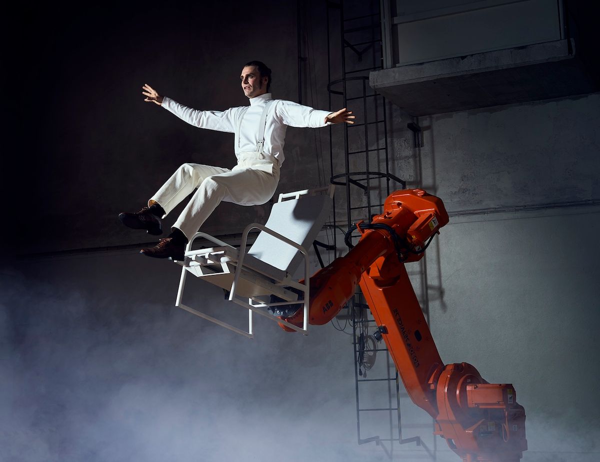 Acrobat Mattias Lindström interacts with an industrial robot during the performance of “The Last Fish.”