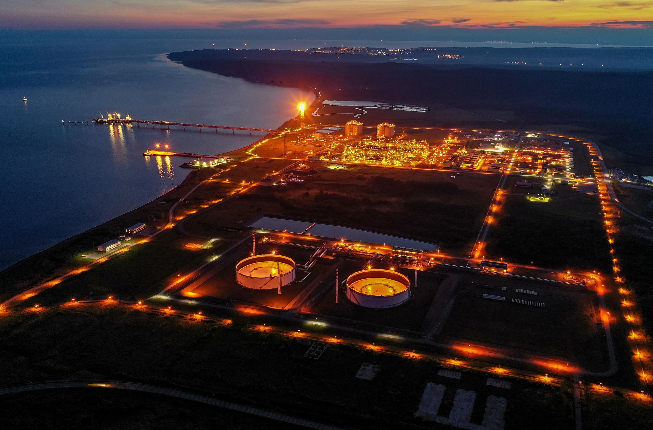 Aerial nighttime photo of an industrial plant on a waterfront