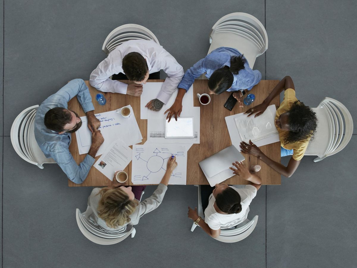 Aerial photograph of a group of people working at a table.