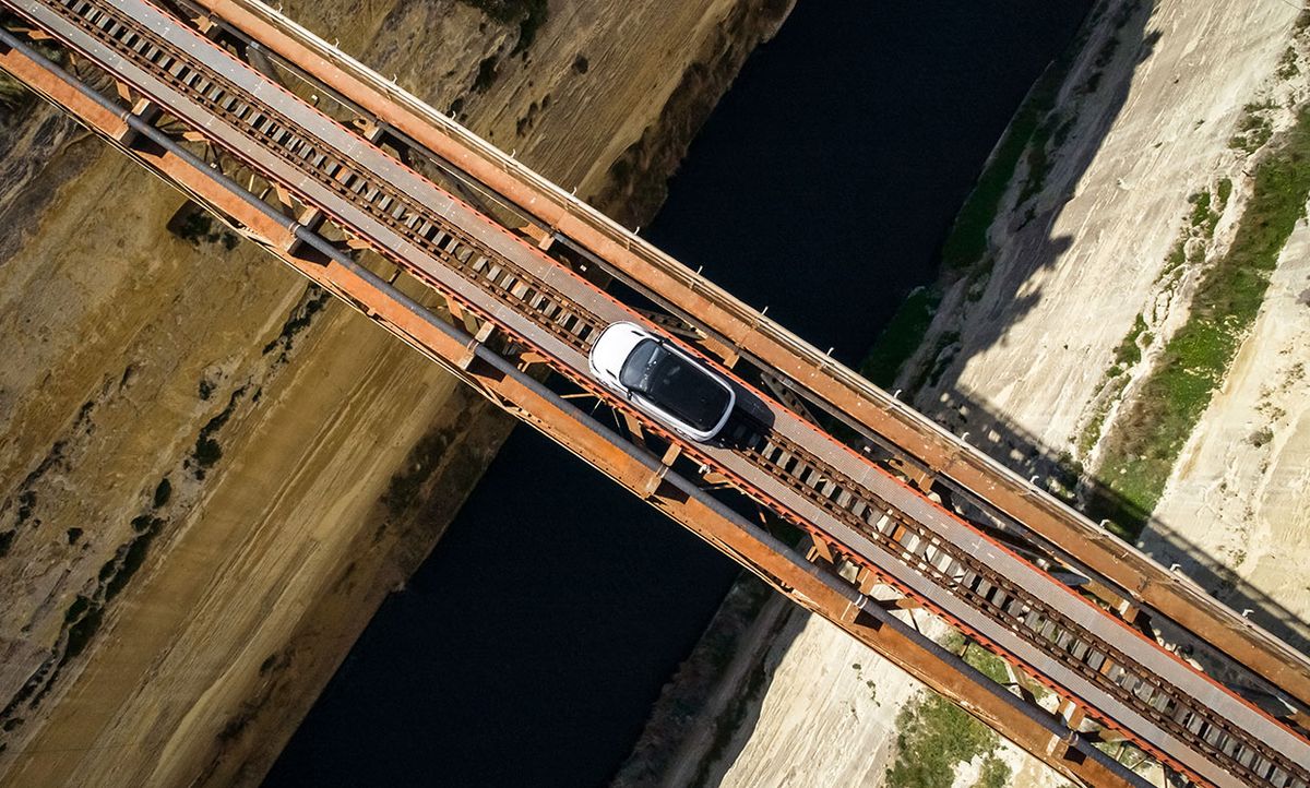 Aerial photograph of the Range Rover Evoque crossing an out-of-service railway bridge in Greece.