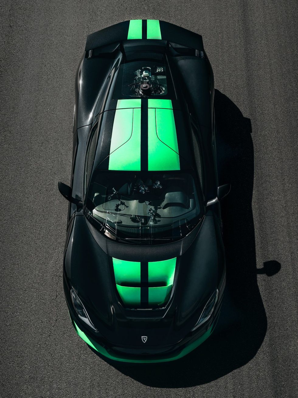 Aerial view of a black and green car on a road