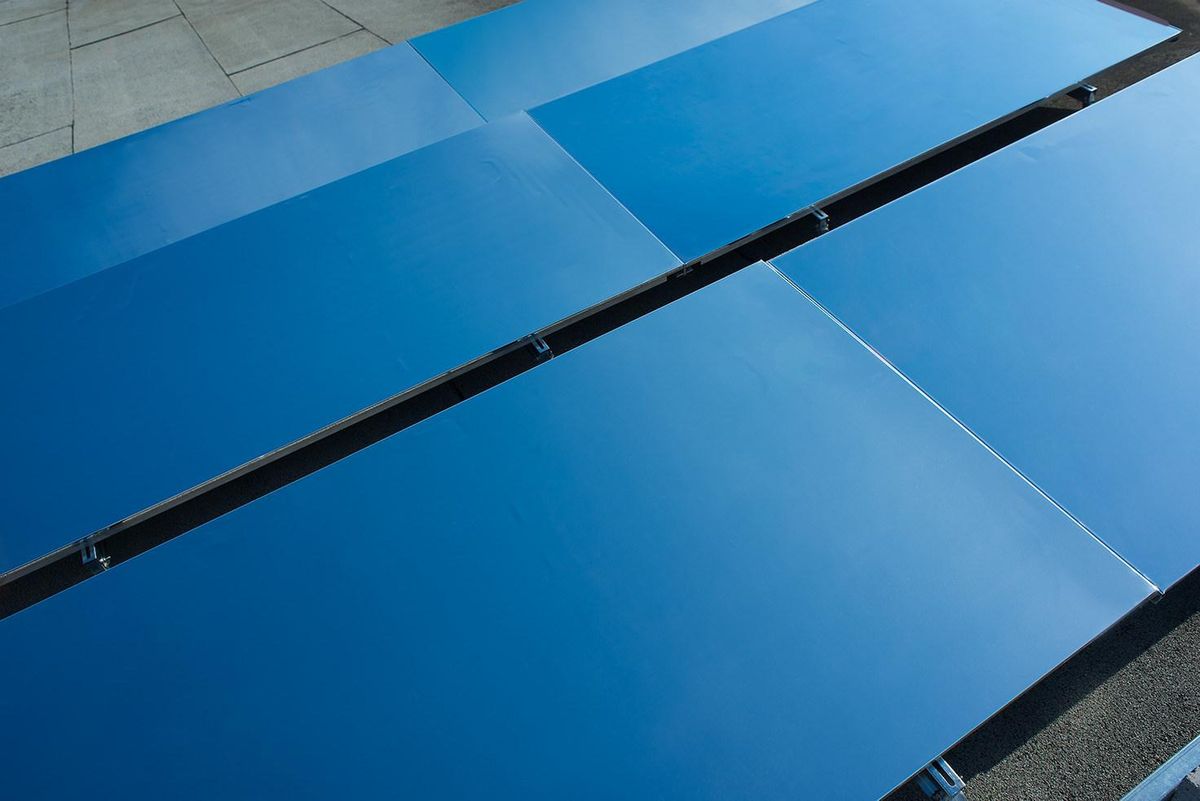 Aerial view of blue panels on a roof