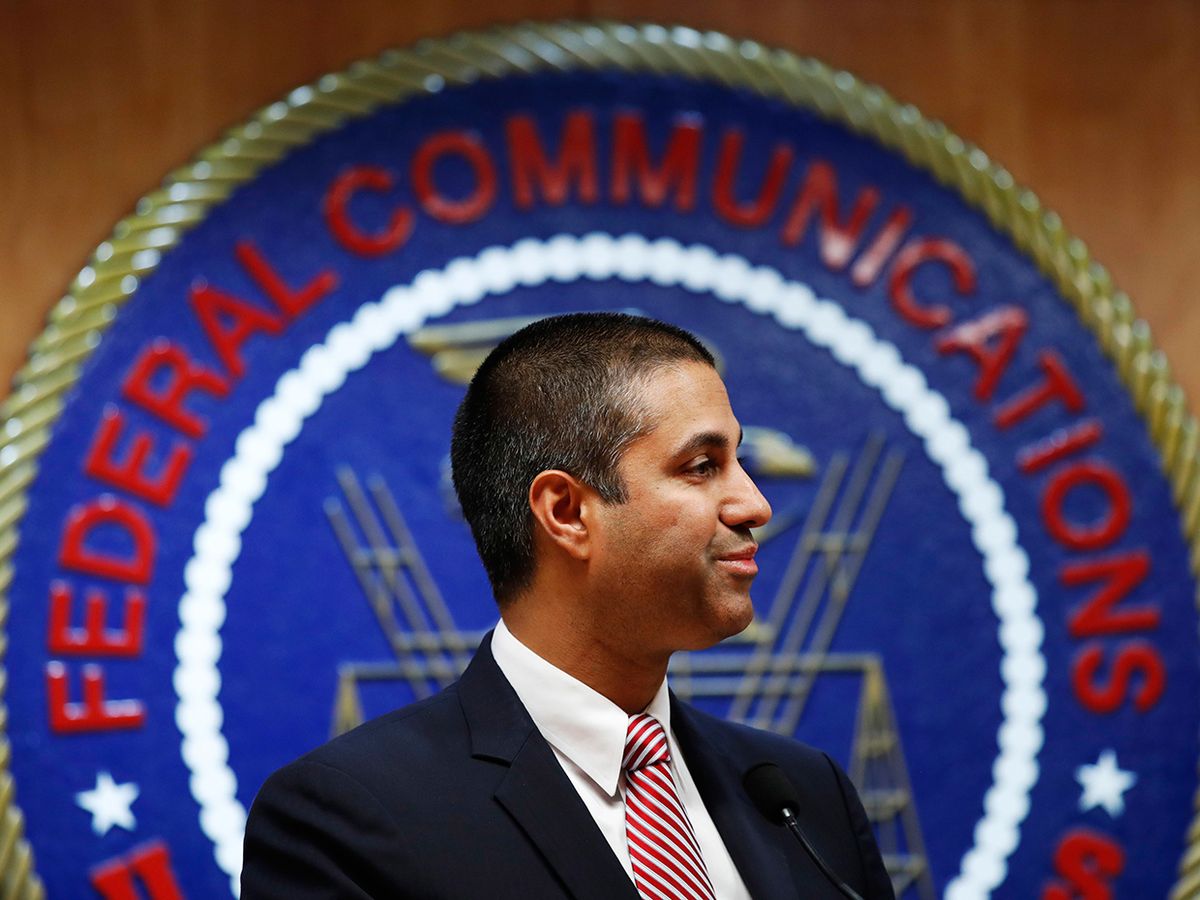 After a meeting voting to end net neutrality, Federal Communications Commission (FCC) Chairman Ajit Pai smiles while listening to a question from a reporter, Thursday, Dec. 14, 2017, in Washington.
