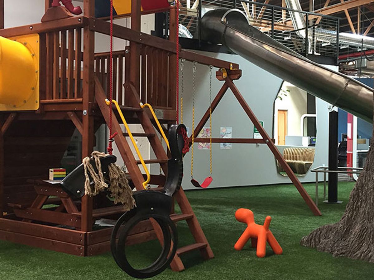An actual playground, complete with swings and a slide, is surrounded by hardware engineering labs and protototyping gear for Playground Global's startup engineers