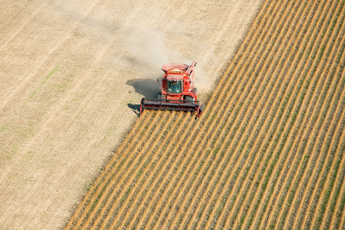 an-aerial-view-of-a-red-combine-harvesti
