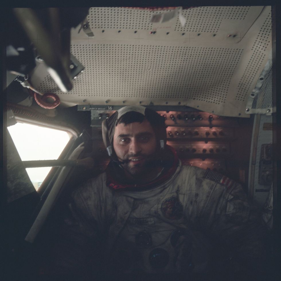 an astronaut sitting in a tight space