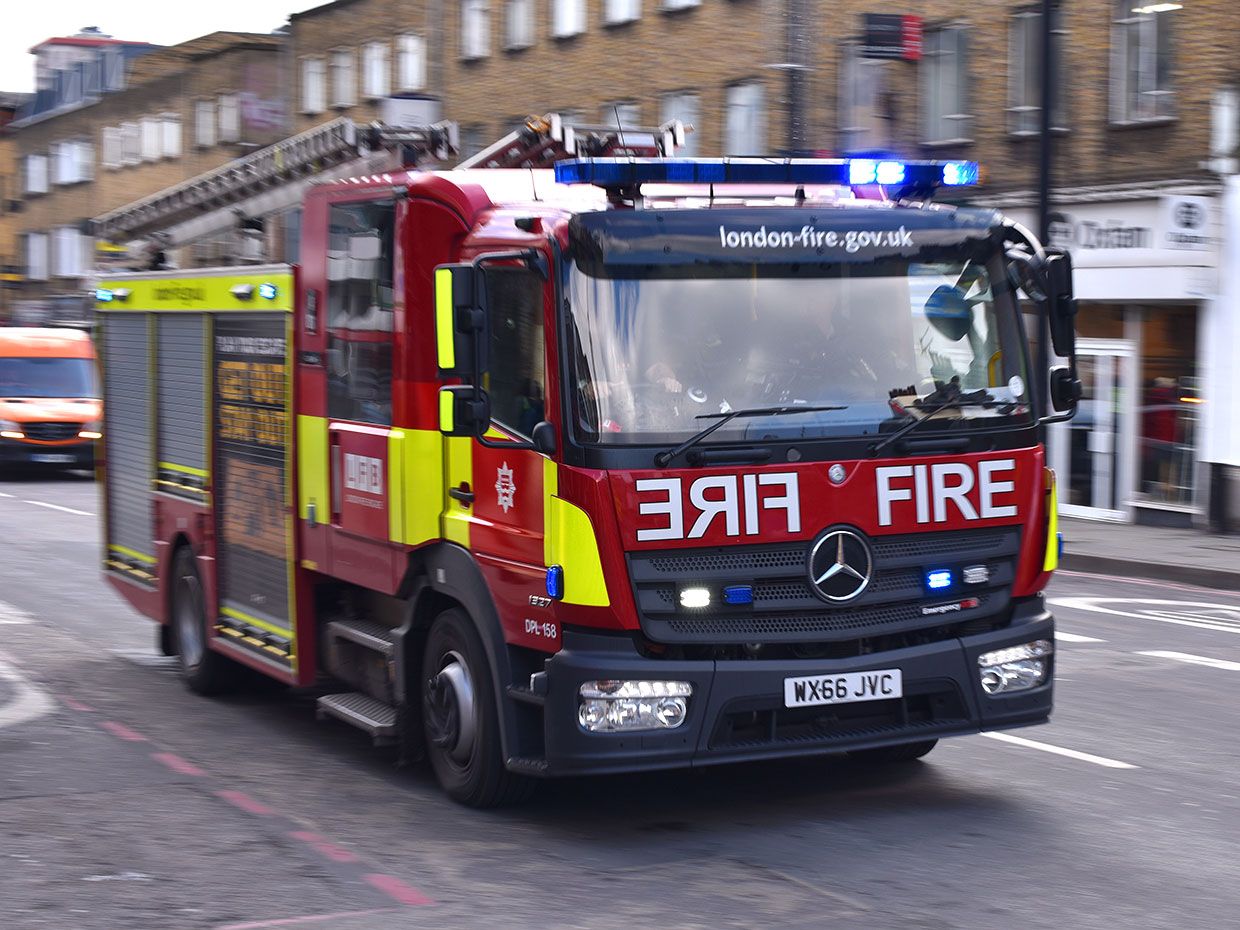 An emergency Fire engine responds to an emergency with in London, England.