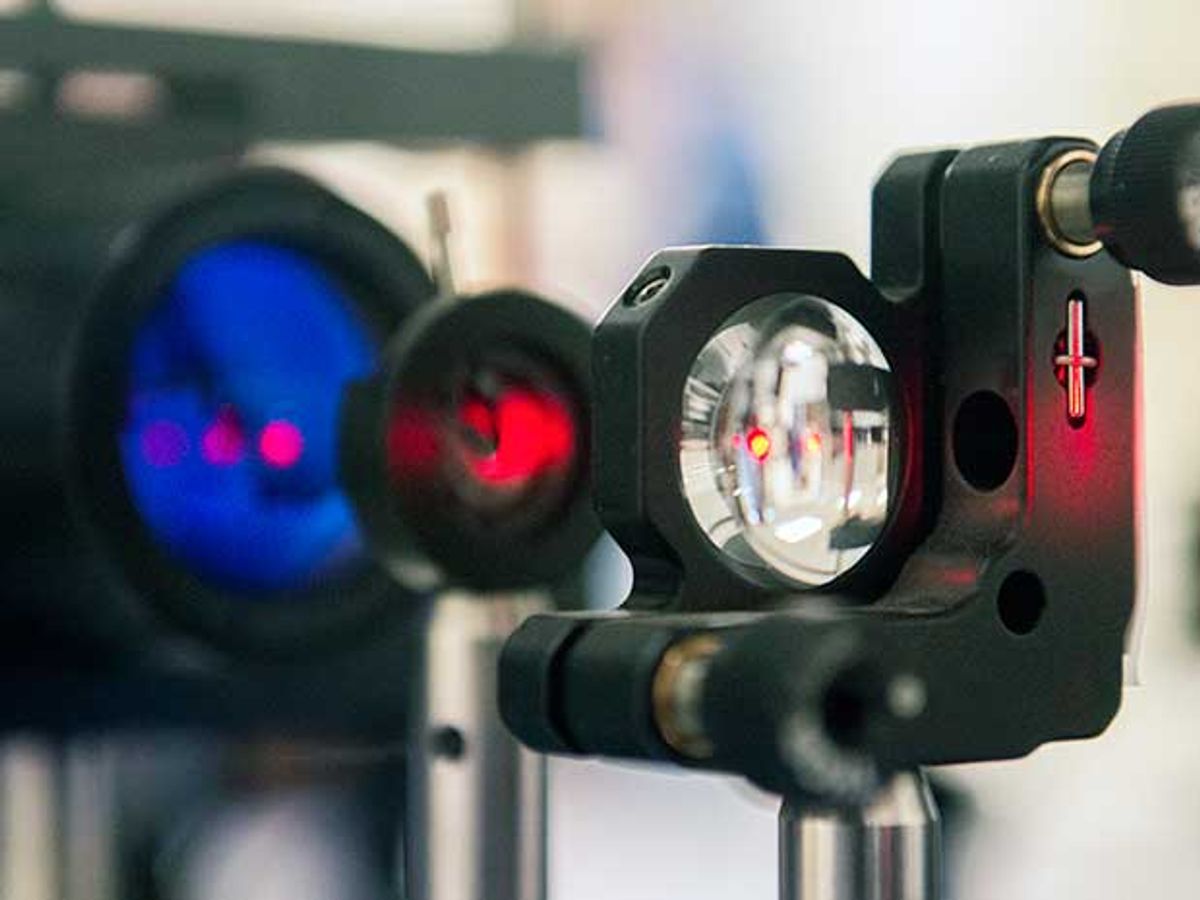 An experimental setup shows a close-up of an infrared laser as it travels through a lens