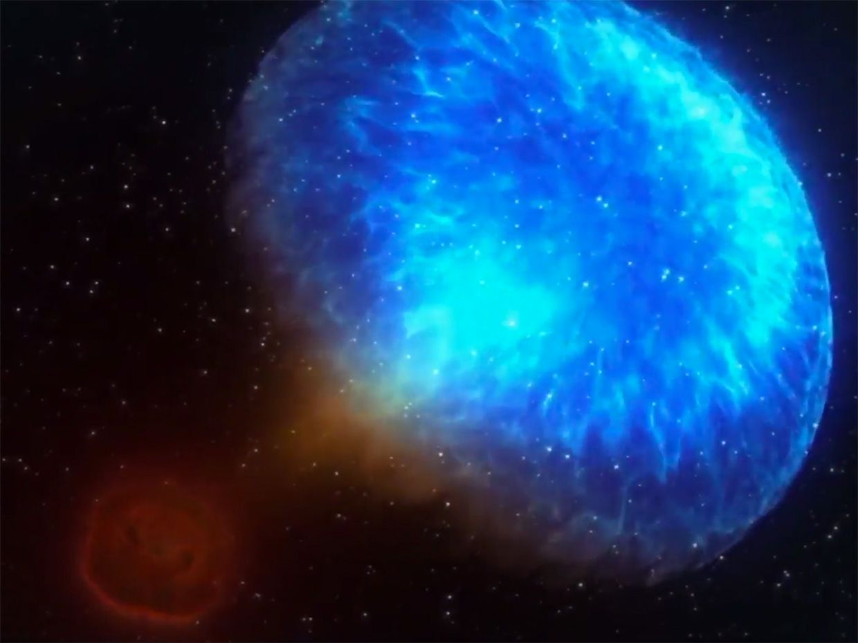 An illustration of a gamma-ray burst shows a blue cloud of bright light against a dark background.