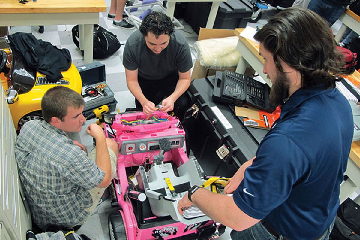 ason Pavich [left], Chris Martin [center], and Garrett Baumann are three of the students at the University of North Florida who helped modify the ride-on cars as part of the school’s Adaptive Toy Project.