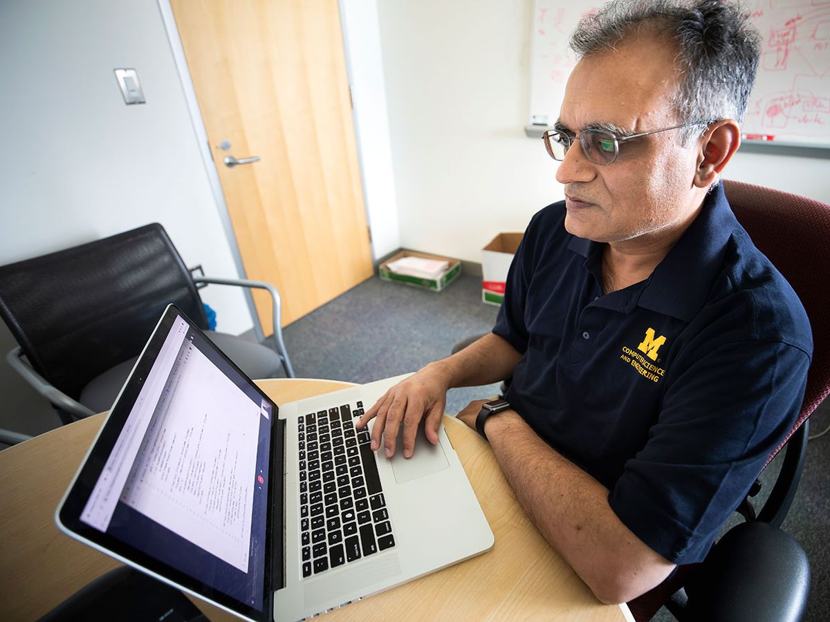 Atul Prakash, Professor of Electrical Engineering and Computer Science, works on code from a project giving Github users an infrastructure to report vulnerabilities.