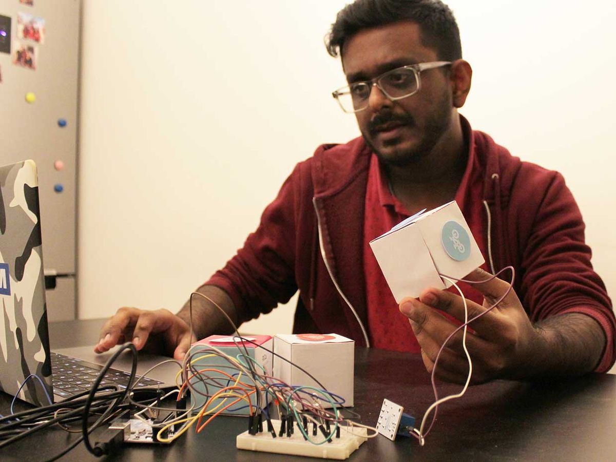 Bibin Parukoor Thomas tests his Ritual Cube (RiCu) device.