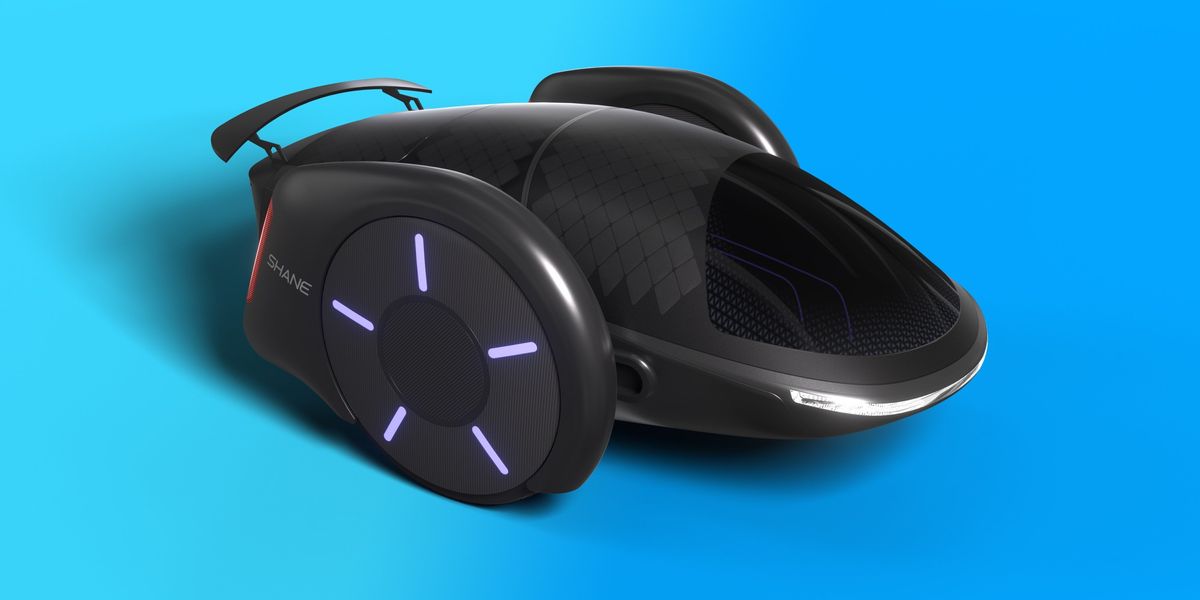 Black, futuristic-looking, two-wheeled electric car, with wheels almost as high as the passenger cabin, sits against a blue background.