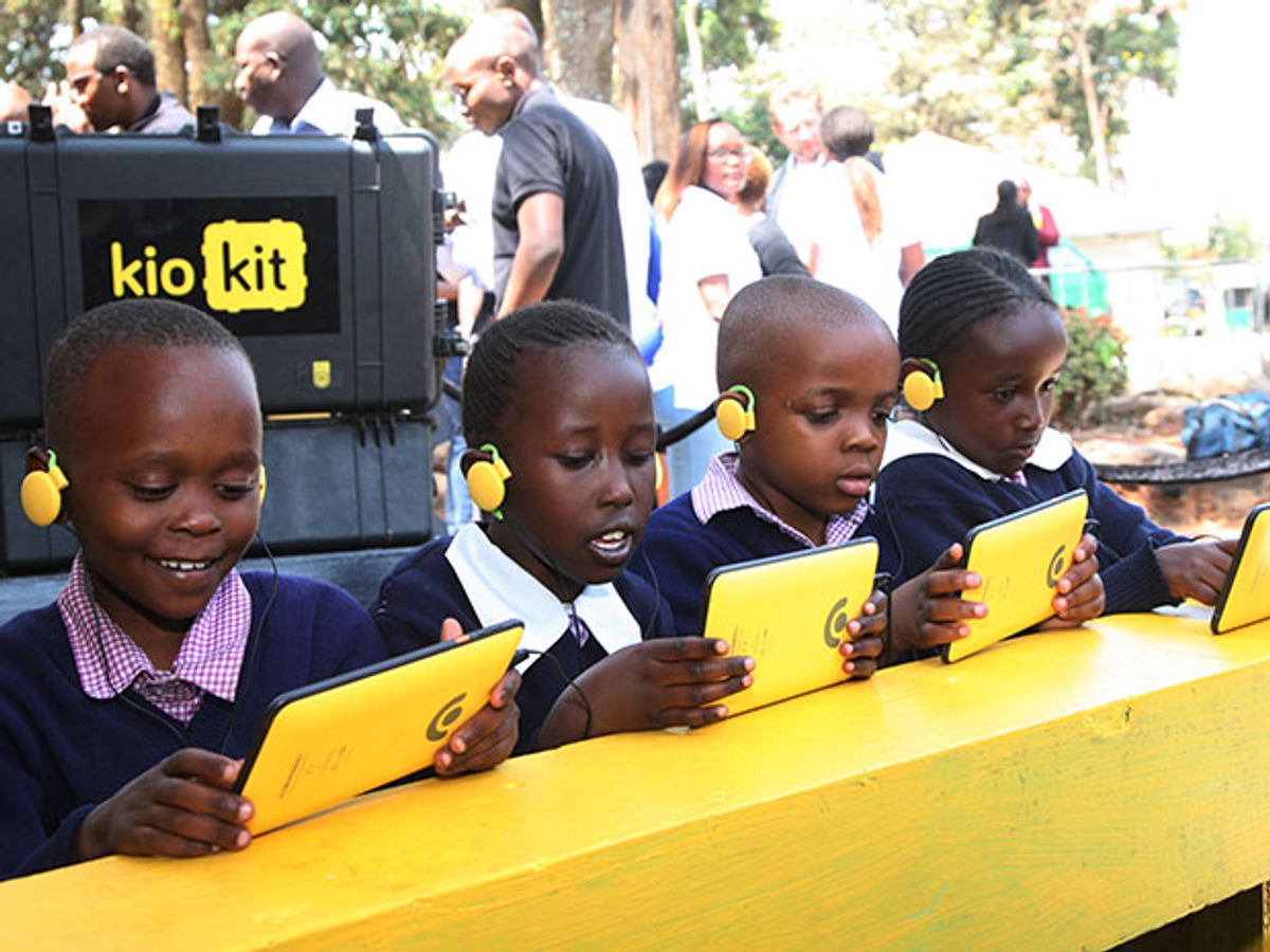 Boys and girls smile as they hold tablets with bright yellow cases